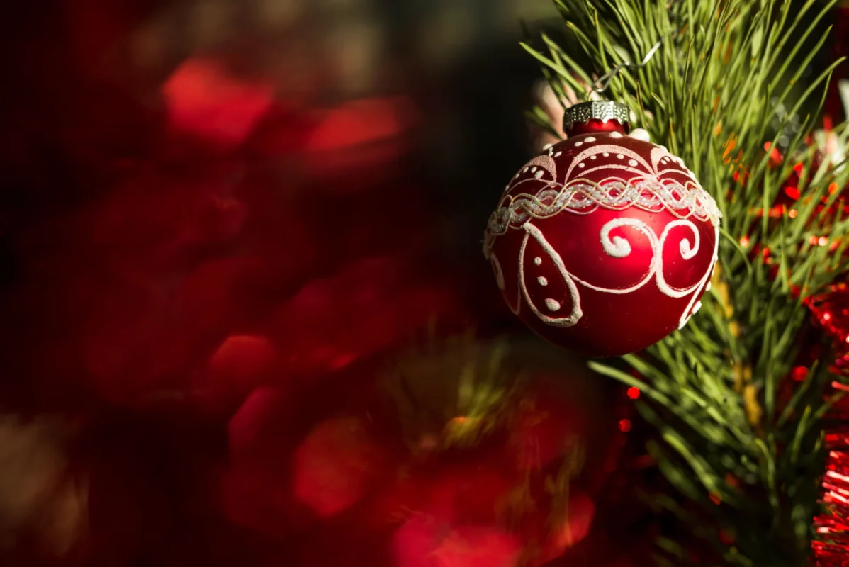 red ornament hanging on christmas tree