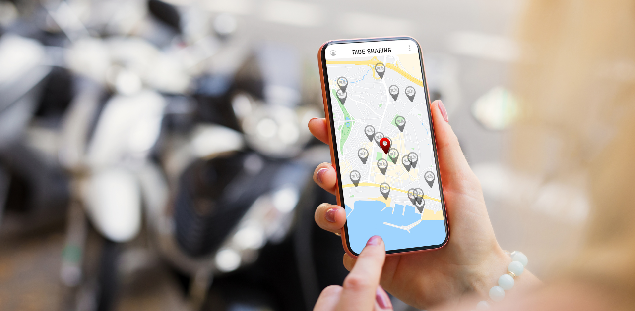 Person using a ride-sharing app on a smartphone, viewing available vehicle locations on a map