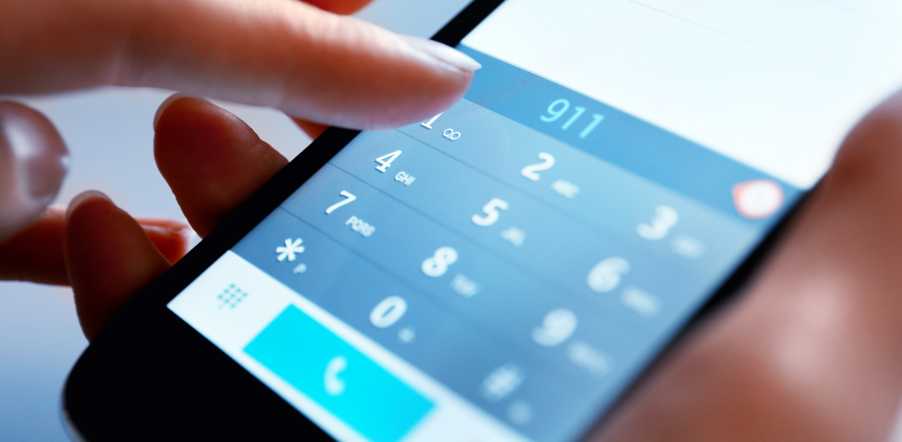 Close-up of dialing 911 on phone, showing fast emergency response in truck driver safety