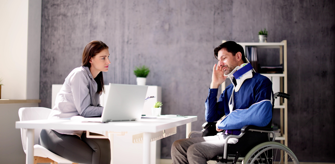Injured man in wheelchair meets lawyer to discuss legal case