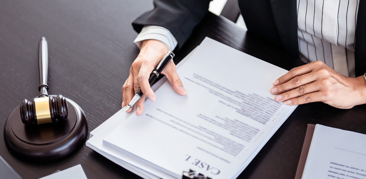 Lawyer reviewing legal documents with gavel on desk