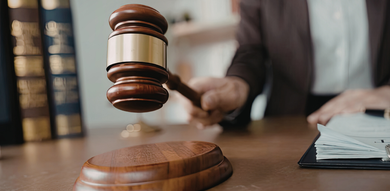 Judge’s gavel striking sound block on desk, symbolizing court ruling, legal authority, and justice decision process